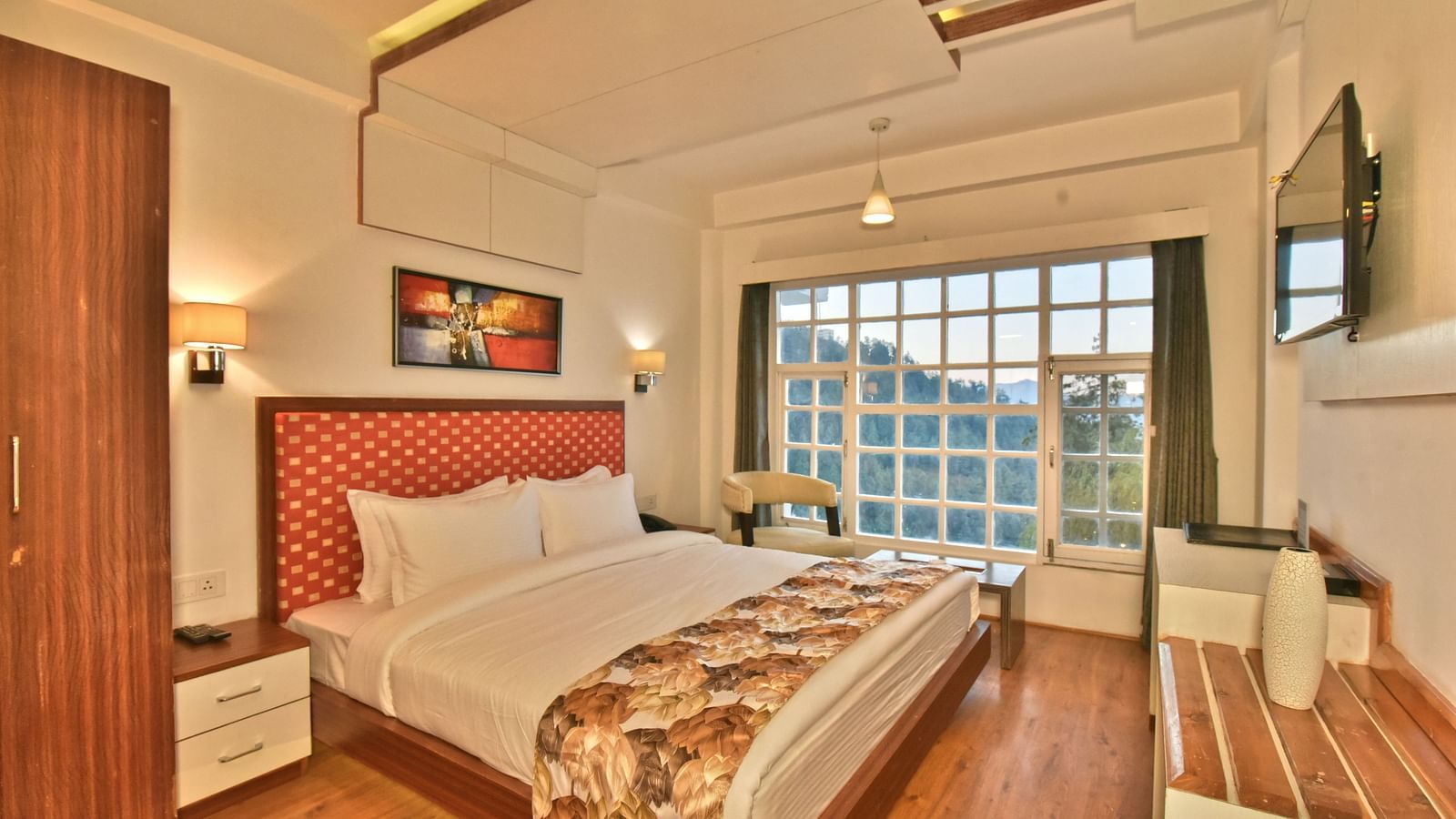 Bedroom with a wooden wardrobe next to it at DLS Hillcrest Resort, Shimla.